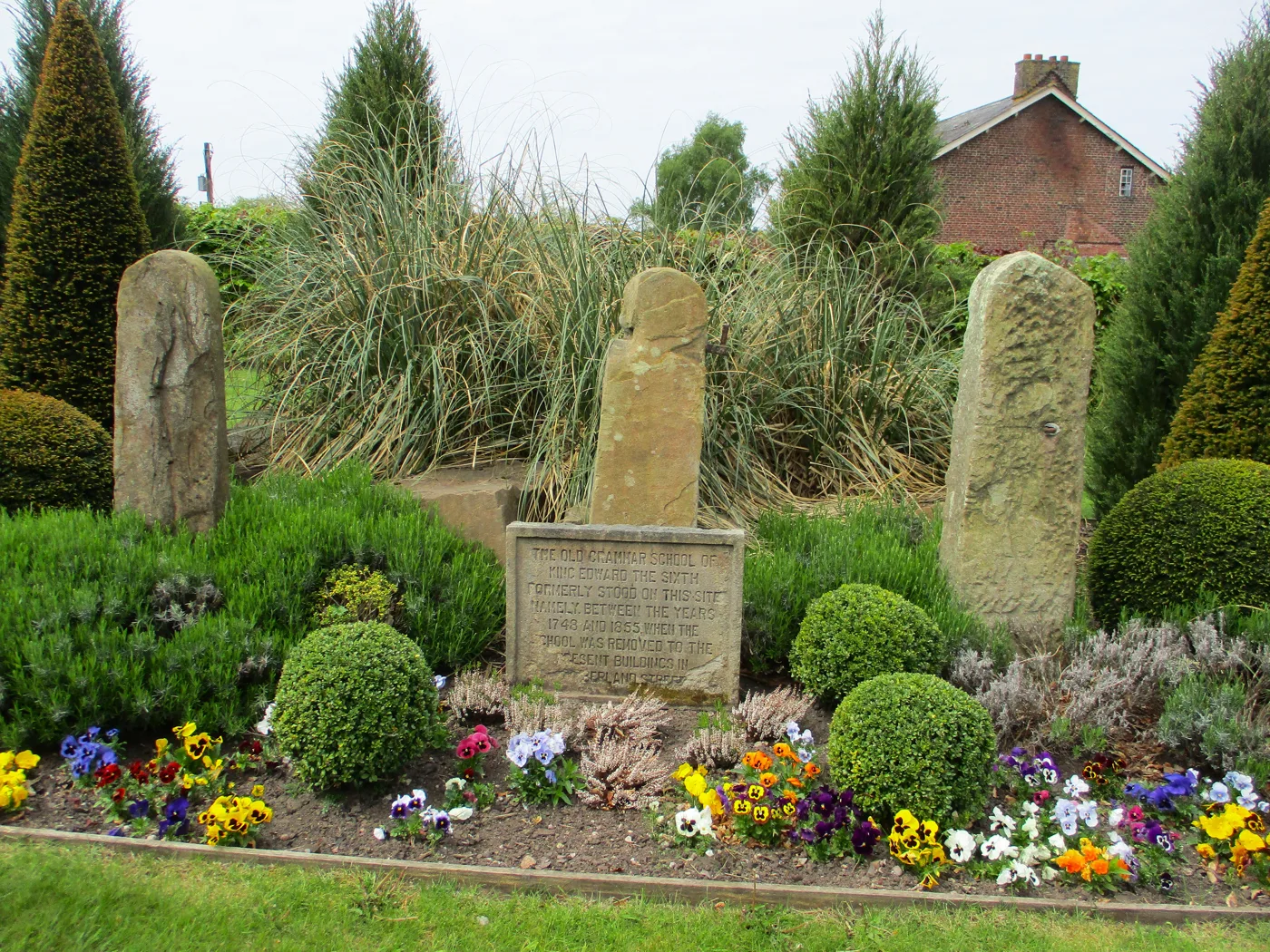 The memorial garden at the entrance to the King's School campus on Alderley Road, photographed in May 2026. The new Forster Pavilion stands elsewhere on the 80-acre site and is not shown here.